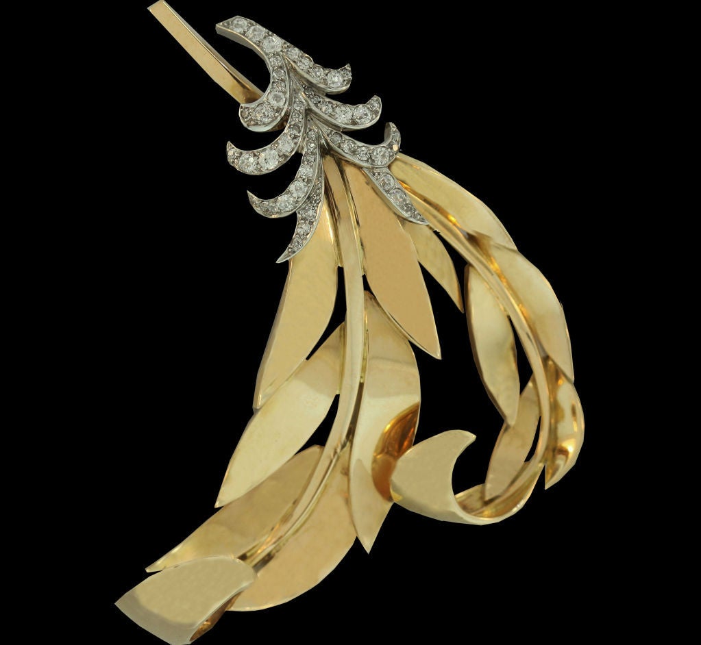 Boasting a true retro pedigree, this brooch from the 1930’s was designed by Regner, Paris. Oversized, streamlined 18K gold feathers create a dramatic silhouette and are topped by a delicate arrangement of diamond-set leaves.