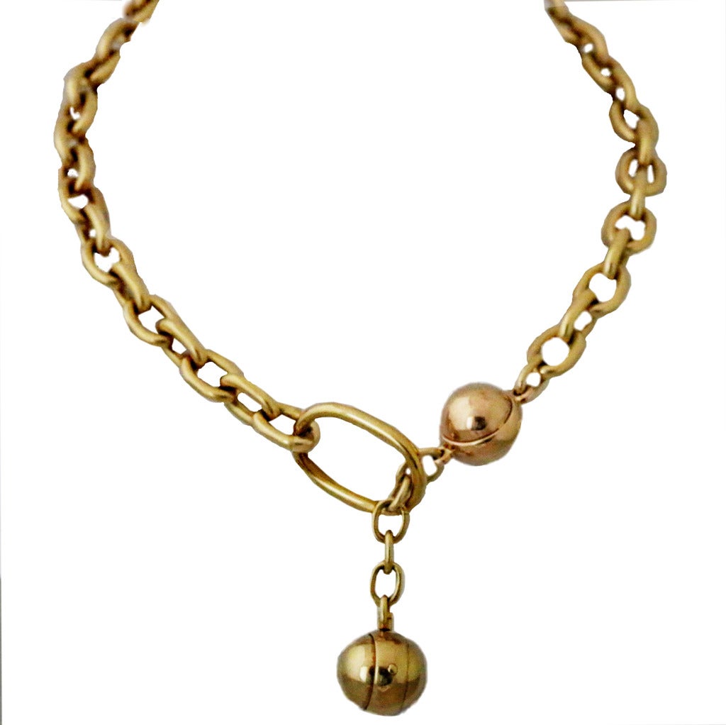 This Italian-crafted, limited edition Pomellato necklace is made from 18K yellow gold cable chain of different-sized links and showcases two substantial 18K yellow gold balls. The necklace 16” long to first ball, with additional 2 ½’ drop.