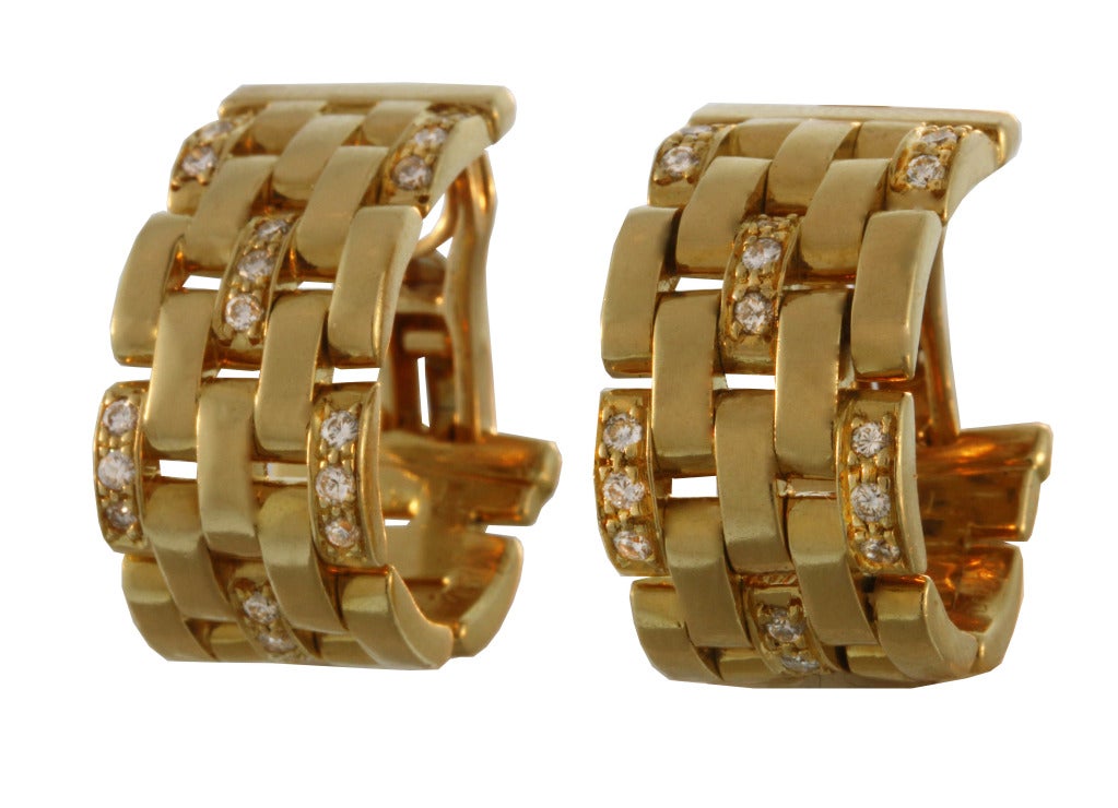 Cartier's classic Panthere link design earrings with diamond accents. The earrings are numbered 771366.