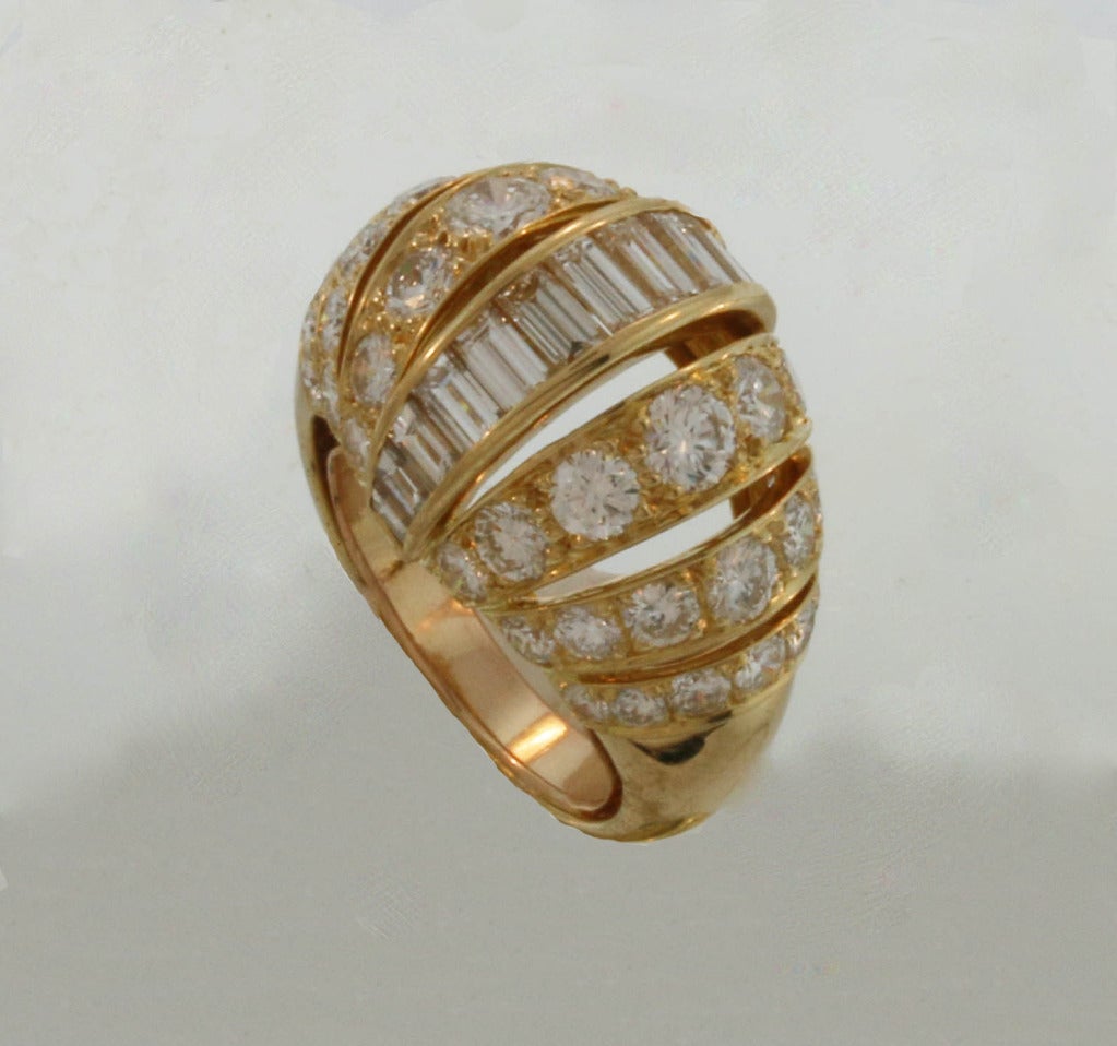 Elegant 'Turban' diamond set gold ring by Cartier Paris. Six rows of graduated round diamonds centered by one row of graduating baguette cut diamonds . A Cartier Classic bombe gem set ring referred to by Cartier Paris as 'a la Turban'. The diamonds