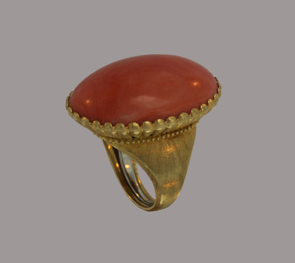 This vintage designer Buccellati cocktail ring is crafted in 18K gold. Circa 1960’s, it features an over-sized coral stone  and has intricate gold-work that exemplifies the best of Italian craftsmanship.