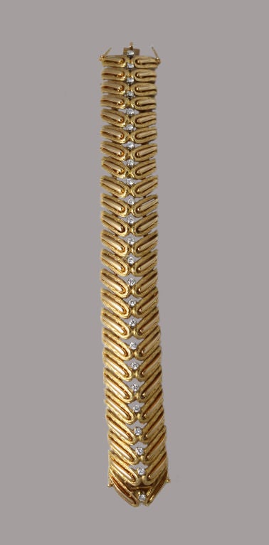 The epitome of retro Parisian style, this substantial bracelet is formed by two rows of angled gold 