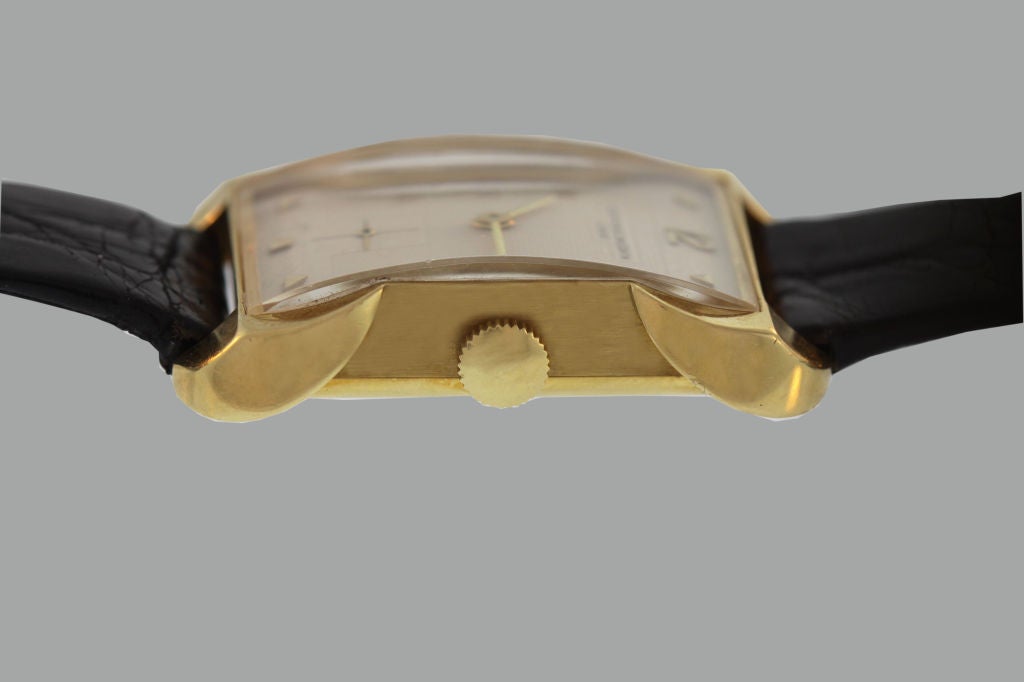 This 18K yellow gold Vacheron & Constantin watch has a streamlined silhouette with extended and rounded corners, and features fancy lugs, gold markers, a sweep second window and the original 18K gold buckle. Circa 1947.
