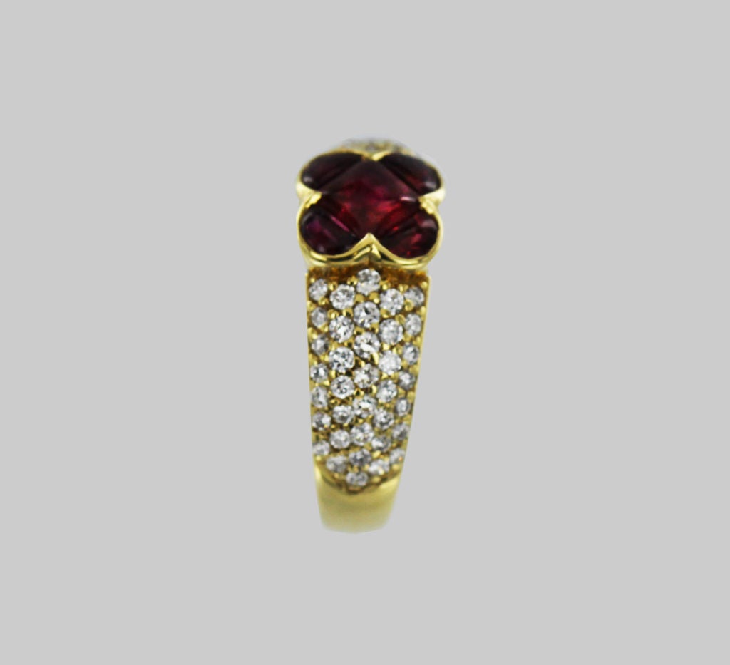 In this dramatic Van Cleef & Arpels ring a distinctive cabochon cut, center square ruby is flanked by 4 half-moon cabochon rubies. The 18K gold band is set with sparkling, round-cut diamonds.