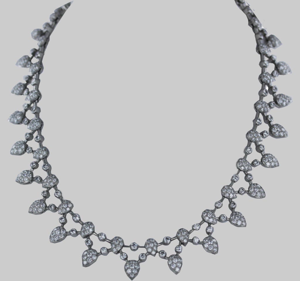From Tiffany & Co. this multi-tiered platinum drop necklace has delicate sections of dazzling pear-shaped diamonds interspersed with single, bezel-set gems and features a total of 25 cts.