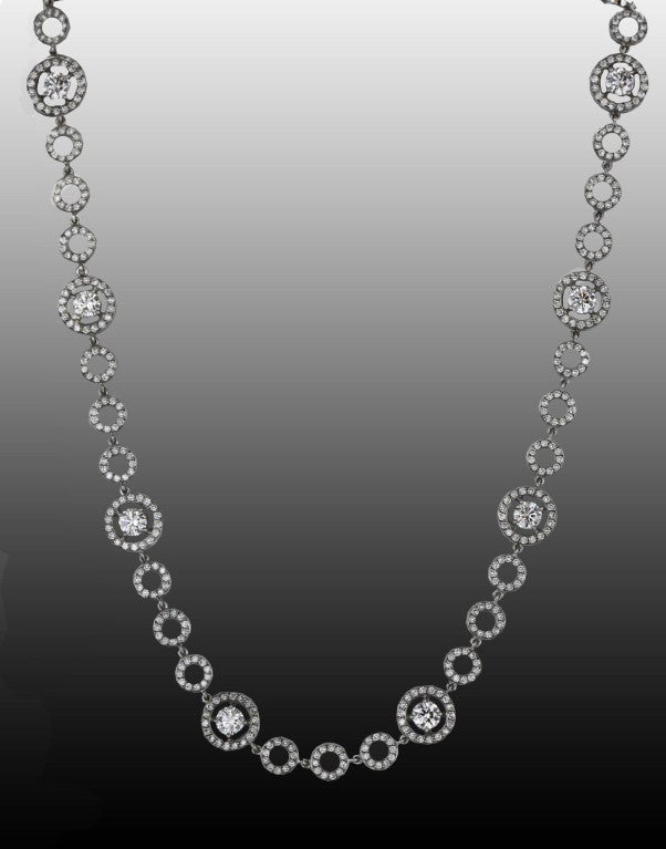 From the famous Boucheron line of jewelry named for film beauty Ava Gardner, the Ava necklace consists of 13 small, open 18k white gold circles set with round diamonds that are interspersed with 11 larger diamond-set circles, each with a substantial