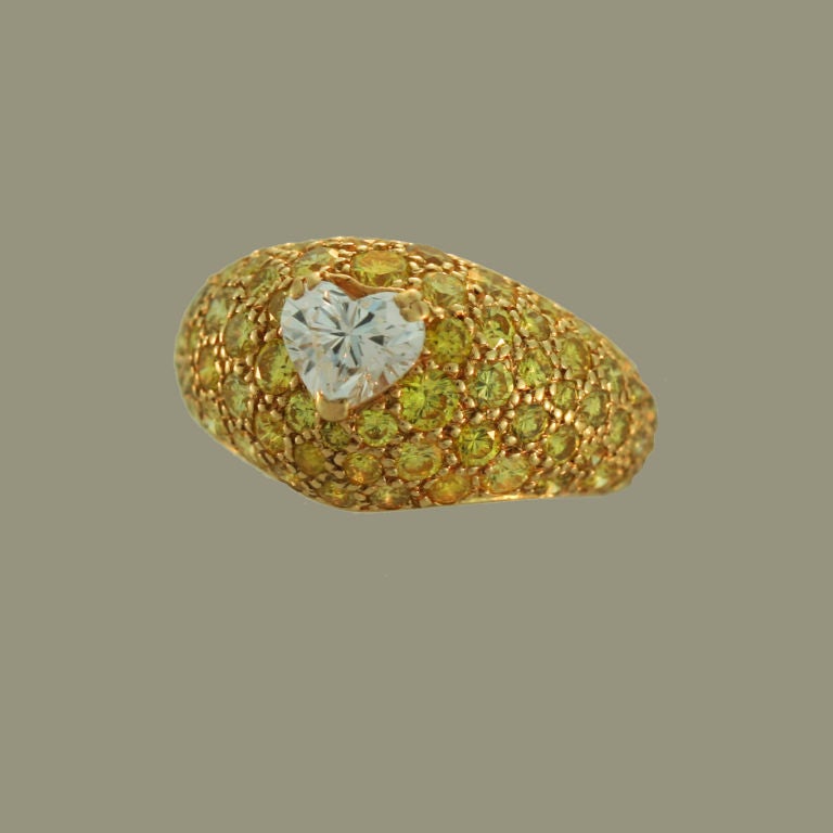 A superb ring by Boucheron Paris designed as bombe pave dome of canary diamonds centered by a beautiful white heart shape diamond.