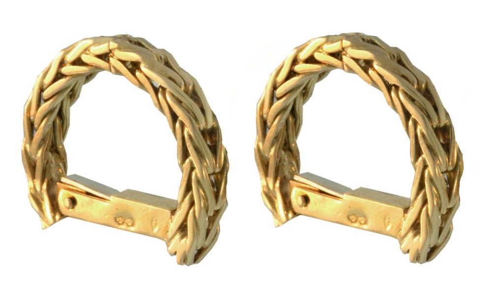 Vintage 70's chic is seen in this pair of woven 18K gold, horseshoe-shaped Hermes cufflinks.