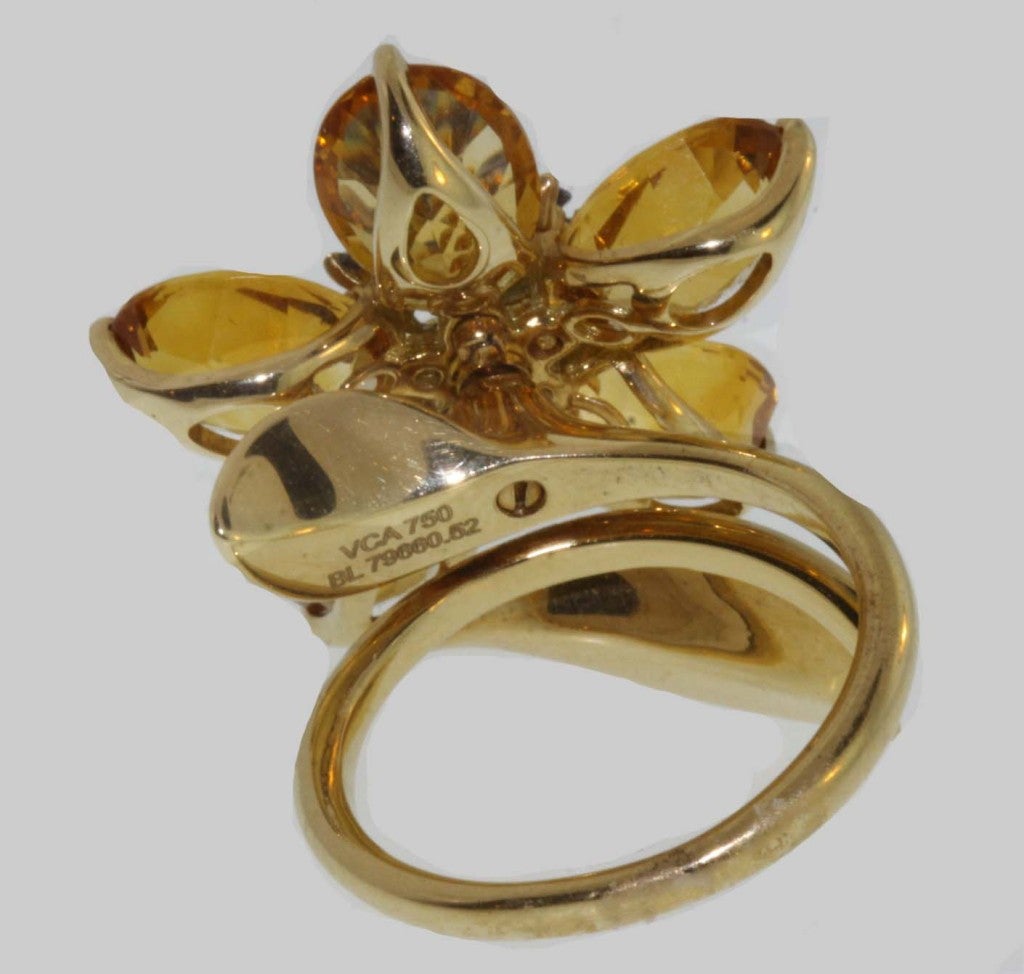 From the Van Cleef & Arpels Hawaiian Collection, this stunning ring is set en tremblant with five deeply hued citrines and a center cluster of sapphires. Signed and numbered BL7966052.