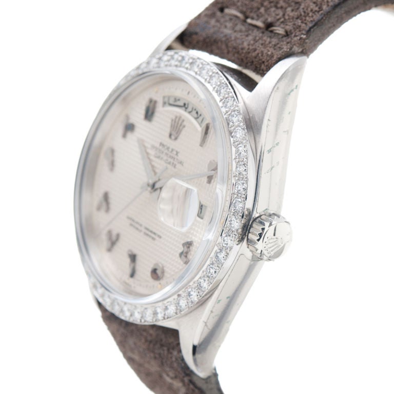 Extremely fine and rare, tonneau-shaped, center seconds, self-winding, water-resistant, platinum and diamond ROLEX Day-Date with arabic numerals, day and date. Rare wristwatch made specifically for the Middle-East market, with unique myriad