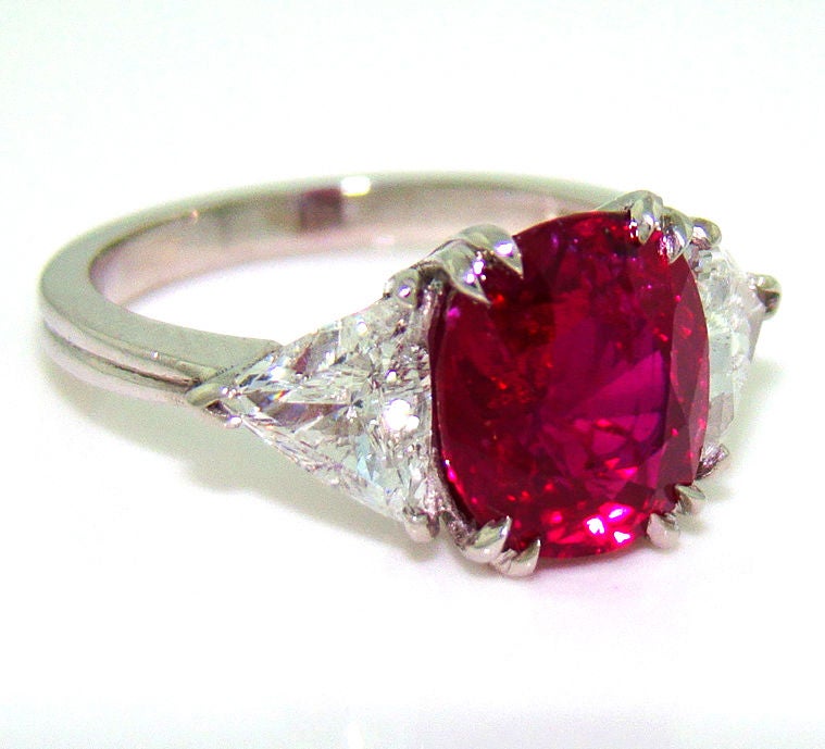 An incredible no-heat and non-treated ruby & diamond ring set in platinum with GIA certificate. The 4.02 carat fine oval cut ruby presents spectacular color deeming it worthy of its ancient Sanskrit name meaning 