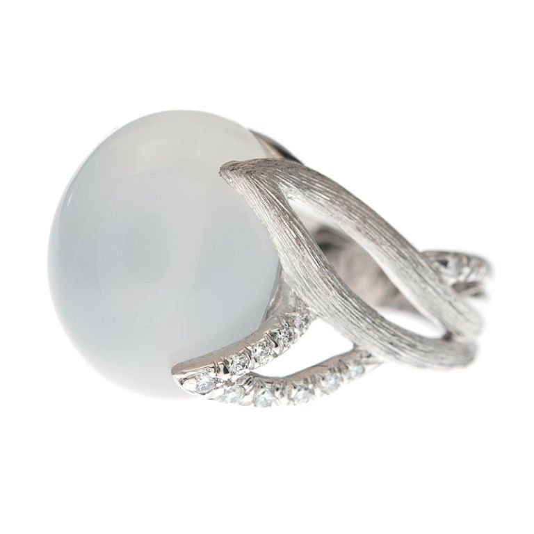 This signed Henry Dunay original features an alluring cabochon Cat's Eye Moonstone. Beautifully rendered in platinum with the signature 