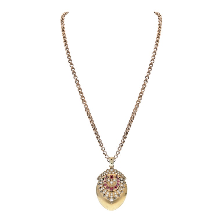 Handmade Locket with 12 Cushion Cut Rubies, 12 Rose Cut Diamonds and Natural Pearls graduated in size complement this charming Classic Victorian design locket with room for two photographs. The handmade 18 Karat Yellow Gold chain, measuring