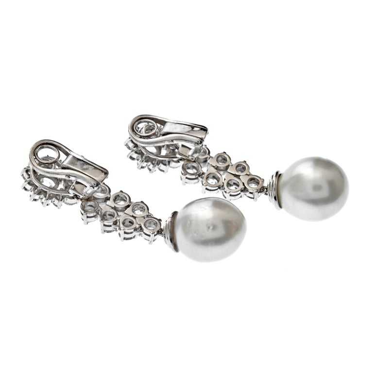  Art Deco Diamond & Pearl; South Sea Pearl Dangle Earrings. 5 carats of Old European Cut diamonds grade G/H color with a clarity rating of Vs/SI. The bottom of the drops illuminate 13 mm South Sea Pearls, measuring 1.9 inches in total length.