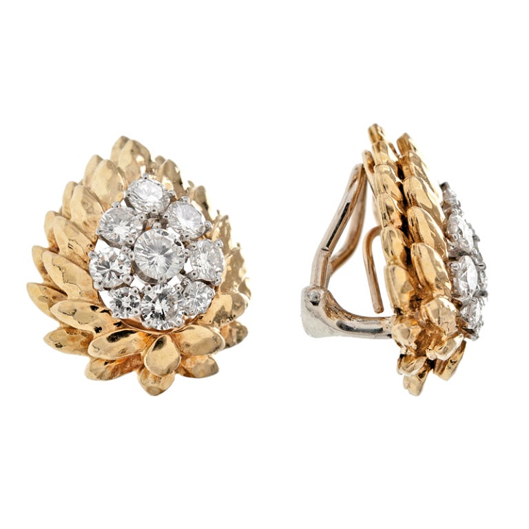 A fine pair of diamond and 18k yellow gold clip-on earrings with a modular post which flips up or down. Two tiers of yellow gold hammered frames encompass the stunning diamond cluster weighing 3.84 carats. A fantastically crafted pair of earrings by