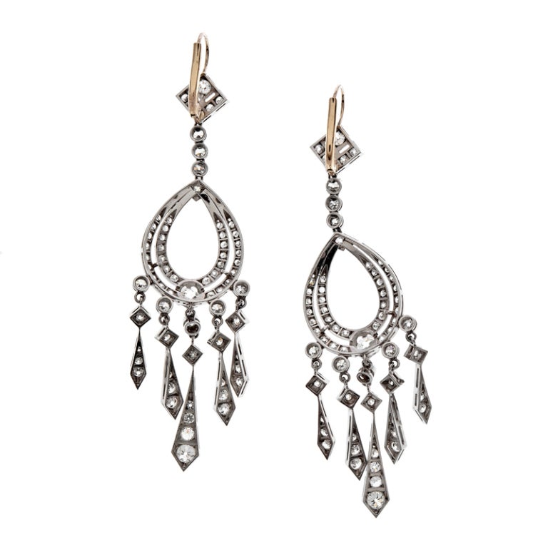 A fine pair of diamond and platinum chandelier earrings, adorned with 136 diamonds weighing over 3 carats.
