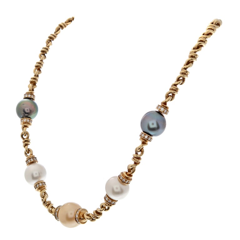 Beautifully hand sculpted gold link necklace with ideally matched sets of black and white pearls and a sumptuous, buttery pearl in it's center. Signed 