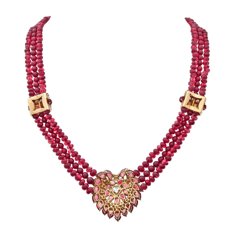 Fit for a princess, a fabulous necklace and earring suite of Burmese rubies. At the focal point of this handmade necklace is a rare antique heart shaped diamond with a open culet, weighing 2.14 carats G color Vs1 clarity. The Burmese rubies in the