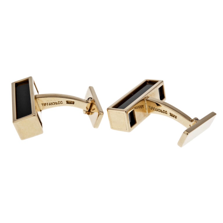 Classic and strong, these cufflinks appear as a rectangular block of onyx, framed on three sides by 18 karat yellow gold. The clean lines of these handsome accessories make them look every bit as fashionable today, as when they were first created by