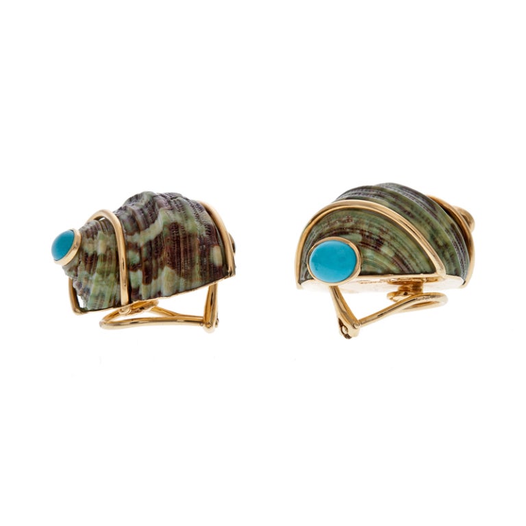 An unusual variation of the well-known classics. These earrings are sophisticated, with an organic, natural theme. The shells are a beautifully matched pair, with waves of rich browns and greens complimented with sweeping polished gold and capped