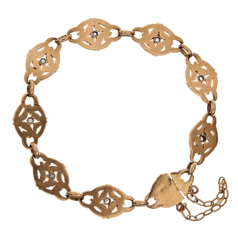 Delicate in style, yet substantial in weight, this French Art Nouveau bracelet crafted of 18k yellow gold, will become the next staple piece in your jewelry wardrobe. Each section is finely hand detailed and dotted with a bezel set diamond. In total
