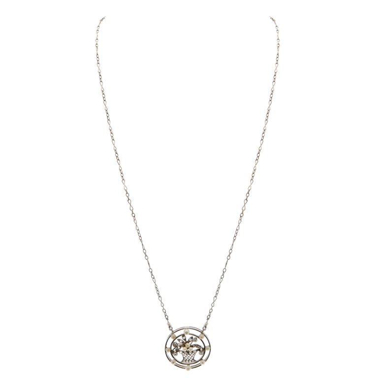 Sweet in nature and abundant with charm, this darling pendant sits fixed to a platinum chain and bursts with enchantment. The pendant and chain are hand made and offer a very  feminine style, with fine detail- the perfect addition to any jewelry box!