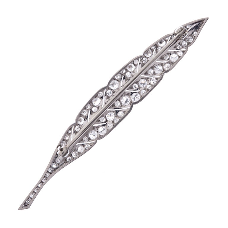 Lovely platinum brooch, hand made with art deco styling and fashioned into a feather, decorated with 66 diamonds.
A nice alternative to a traditional bar pin, this has a pleasant shape and is the ideal decoration for your lapel. I suppose it could