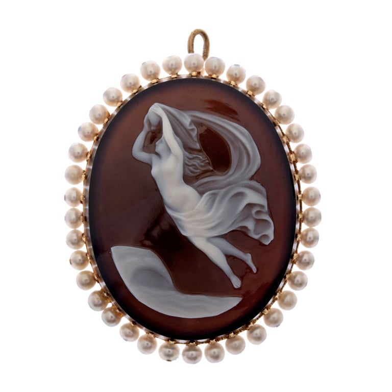 Extremely fine Victorian cameo suite of earrings and a pin/pendant. The earrings measure 1 inch tall and 3/4 inch wide. The brooch has a large pin back and a bale and can be worn as a pendant. It measures 1 3/8 wide by 1 5/8 tall. Seed pearls
