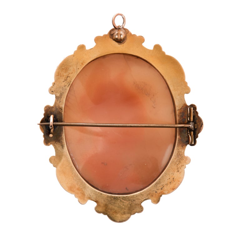 Extremely fine Victorian shell cameo encased by an 18k yellow gold repousse bezel and containing a mythological portrait. A hand-carved cameo and hand forged bezel with curls of gold, alternating in directions and almost dancing around the