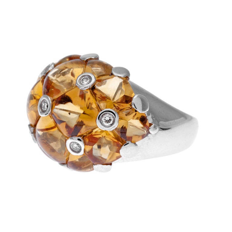 Custom cut citrine, fashioned into smooth shapes and pieced together with bezel set diamonds to create a honeycomb pattern. The ring is made if 18k white gold and has a genuine dome shape, which is entirely smooth on top. Seven diamonds are peppered