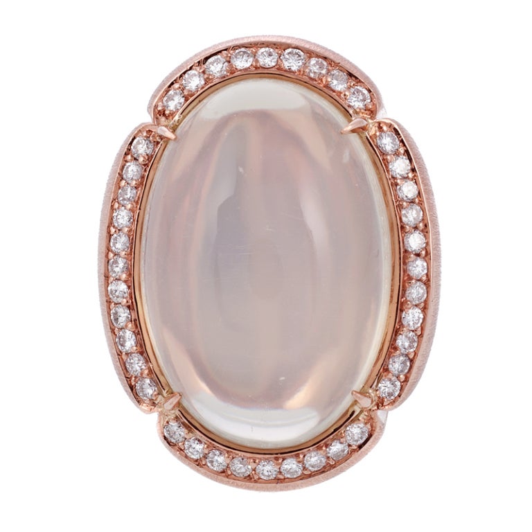 A soothing play of rose gold color and soft moonstone glow exude a warm and soothing ambiance. The 51 carat moonstone remains in proportion to its setting, a testament to its design which allows such a large stone to be worn with ease. The overall