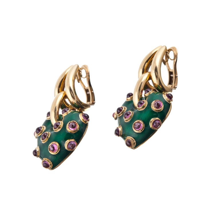 Bold, fun, golden... These striking earrings evoke the best of the playful nature of 1980s style. High polished gold with vibrant green enamel and transparent cabochon pink tourmalines, fashioned into a puff heart. The heart swings  on a golden