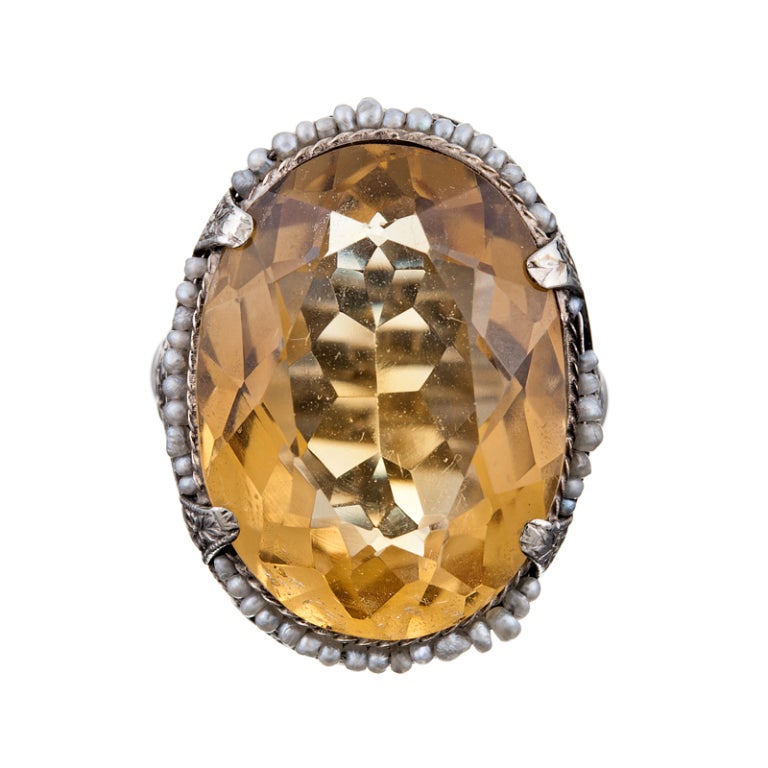 Fantastic vintage cocktail ring with gorgeous filigree, hand carved and engraved in 14k white gold. At the center, a large oval citrine, contained in a four prong setting with even more engraved detail, surrounded by a row of seed pearls. A lovely