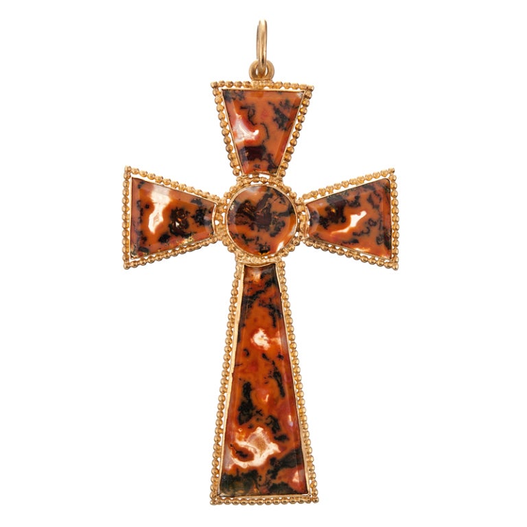 An unusual and beautiful cross in a rather assertive size, measuring 2.25 inches long, by 1.5 inches wide. The photographs show much light though the agate, however, when it is being worn against fabric or skin, the pattern has a more opaque