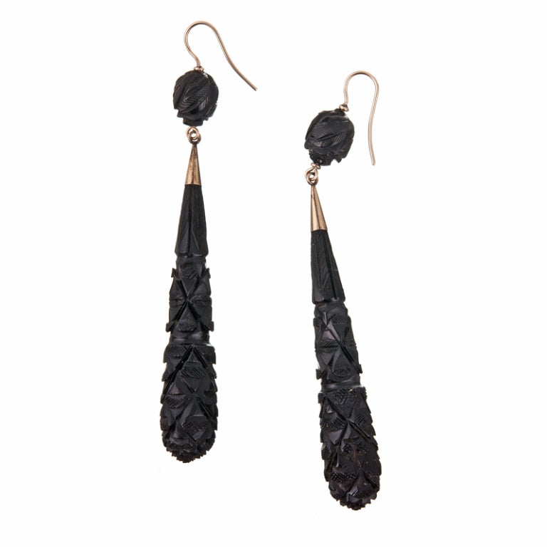 Extra long earrings, especially for the period, these beauties measure nearly 4 inches in overall length. Carved jet is lightweight and comfortable, however, these earrings have all the high style and drama of far more substantial material. Carved