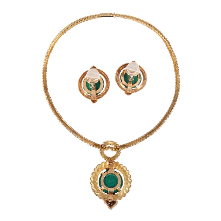 Bold jewels fit for the most sophisticated of enthusiasts: A necklace, earring and ring set, made of twisted and dual-textured 18k yellow gold, gorgeous malachite and freckled with appropriately-placed diamonds. The earrings currently clip on and