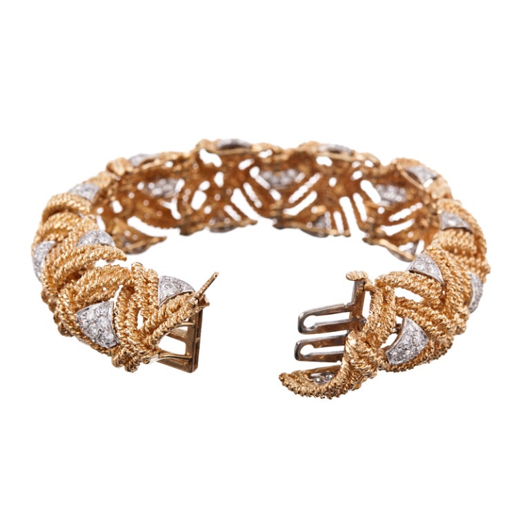 The artistry and inspiration of David Webb never cease! This bracelet is a substantial creation, forged of twisted golden ropes, woven together in a braided pattern and decorated with diamond- and triangle sections of diamonds. The diamonds are set