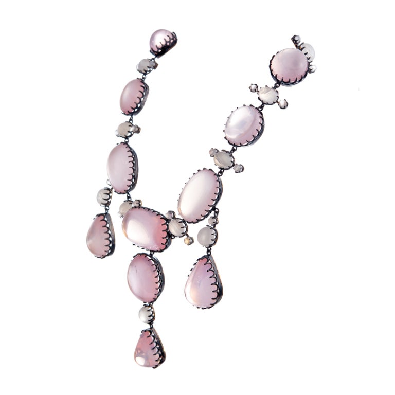 A robust and regal rose quartz and moonstone antique inspired necklace. Set in 18k yellow gold, its blackened silver overlay and scalloped bezels alludes to a stye of jewelry making a century old. It's size is substantial, a design more in line with