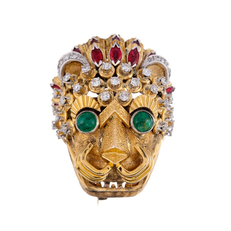 Cabochon emerald eyes, a feathered ruby headdress and a crown and ears of diamonds? This finely detailed mythical beast commands attention and praise for his inspired design and superior execution. Crafted in 18K yellow gold and platinum. 1.5 x 1.25