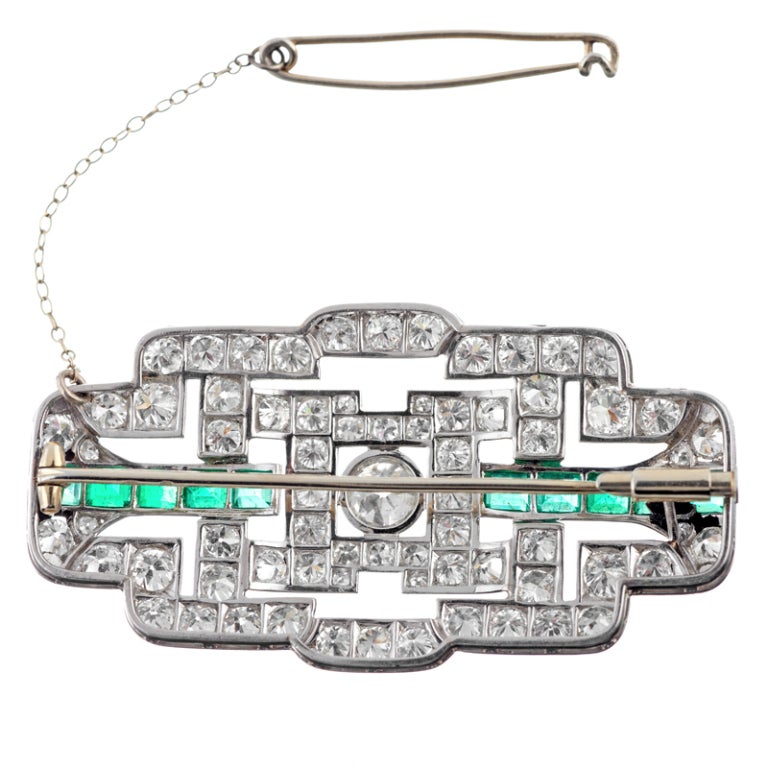 Measuring 2 inches wide by just over an inch tall, this lovely art deco piece encompasses all that is celebrated about this nearly century-old design style. Graphic lines, mixed with brilliant gemstones result in a substantial piece, which will most