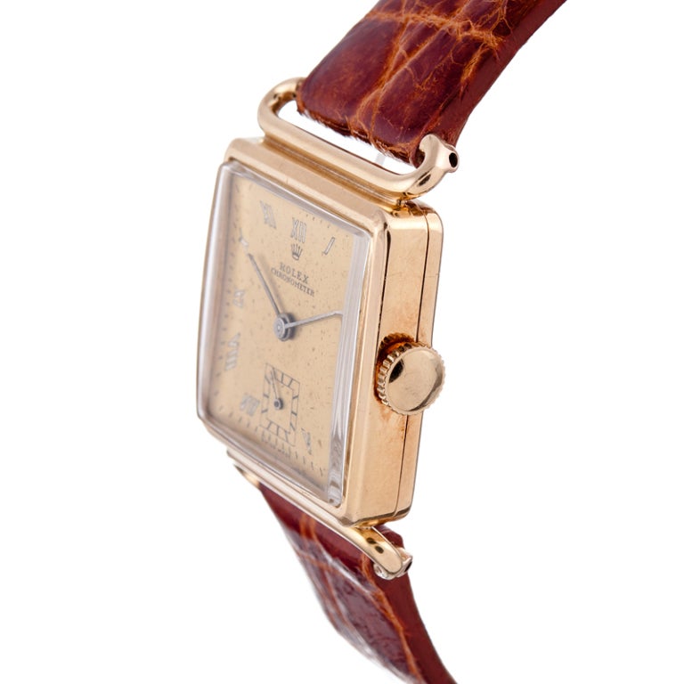 Rolex made very few square watches over the years. This is a great example, suitable for a lady or a man. The 14 karat rose gold case measures 25 mm wide and 30 mm tall and boasts very unusual and attractive lugs. The dial is original with