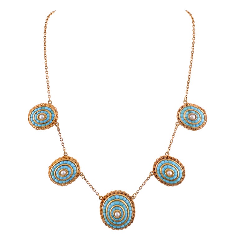 Substantial in its execution and design, this is the epitome of antique jewelry which looks relevant for today's fashions. The necklace consists of five ovals, spaced just under an inch apart, and graduated from 7/8 of an inch to 1 1/8 inches in