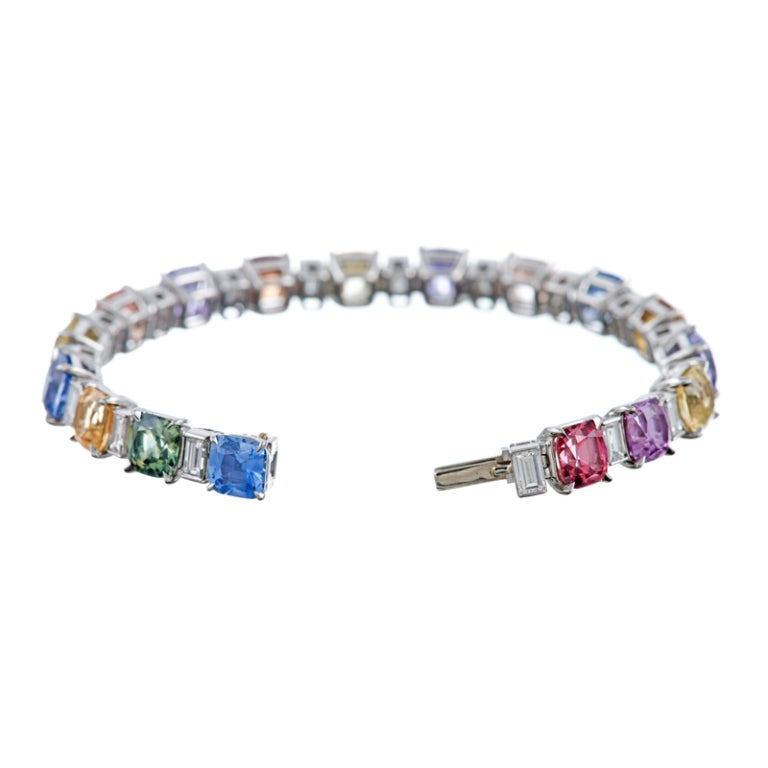 Stunning, dazzling, brilliant and simply beautiful collection of assorted No Heat Sapphires, alternating with baguette cut diamonds in a truly spectacular, unending ring of deep pastel-hued gemstones. Each stone has been hand selected for its