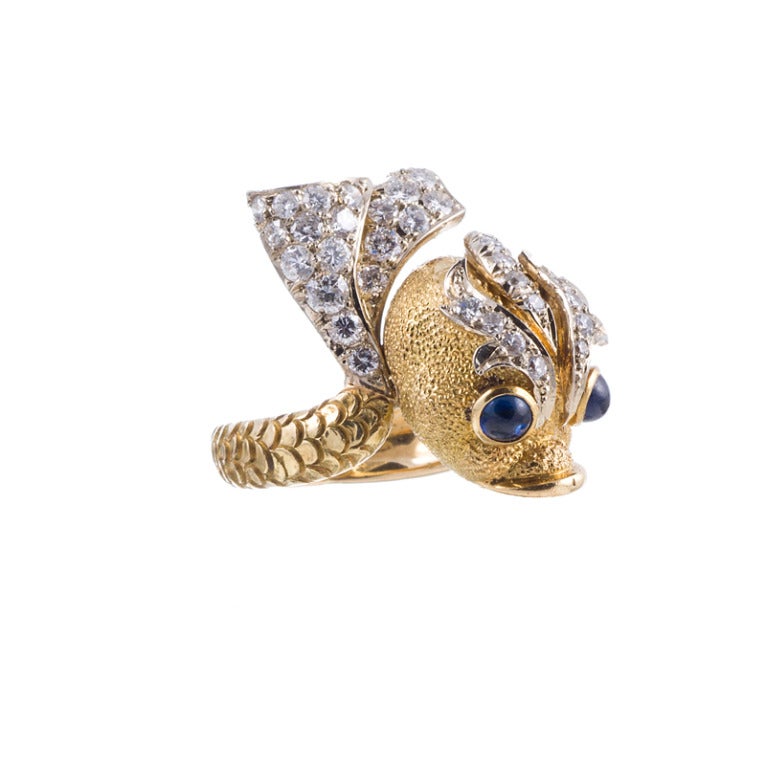 Fantastic piece, with extraordinary attention to detail. Every aspect of this little fish has been finished with tremendous skill: his polished lips and bezels around the cabochon sapphire eyes, the three-dimensional scales that follow the entire