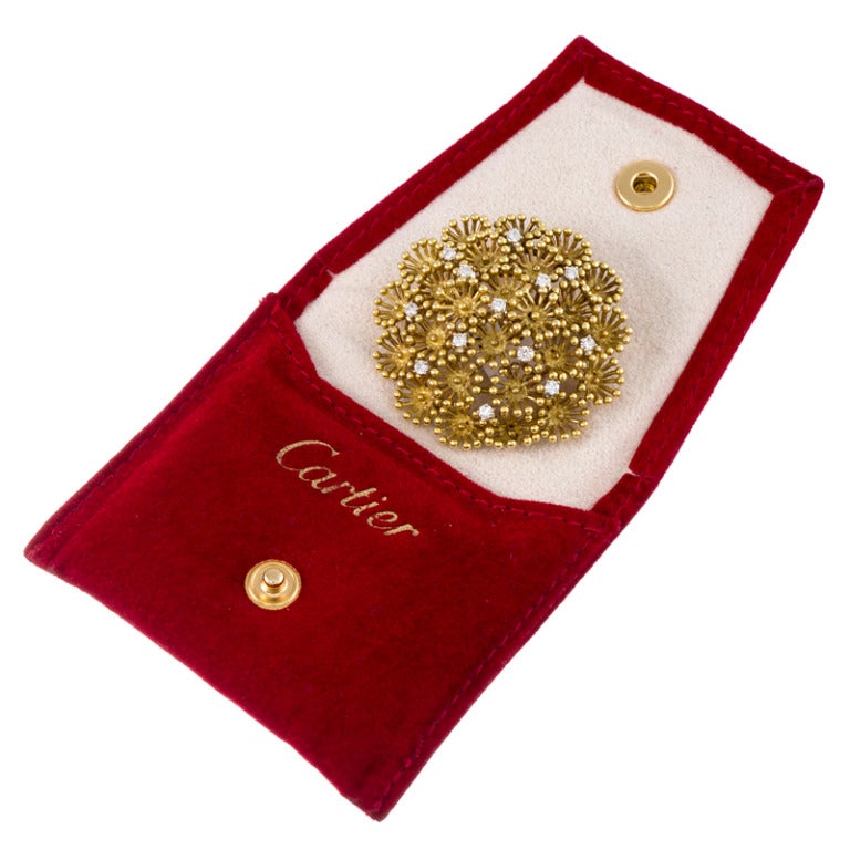 Charming brooch appearing as the top of a bouquet of flowers and speckled with brilliant diamonds. The brooch measures 1 5/8 inches in diameter and is finished with both a high polish- and a satin finish. The diamonds weigh just over a half carat in