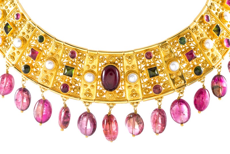 This masterfully fabricated collar is a triumph of color and craftsmanship with delicate Etruscan style wirework and  granulation. Beautifully adorned with alternating cabochon  pink tourmalines, creamy pearls and vibrant peridot, this gorgeous