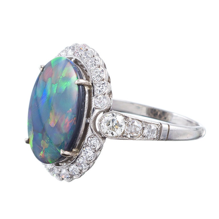 Lightning Ridge Black Opal, Diamond and Platinum Art Deco Ring. Lightening Ridge opal is some of the finest opal material known and this is a gorgeous example. The opal weighs 3.90 carats and is complimented by approximately 1 carat of brilliant