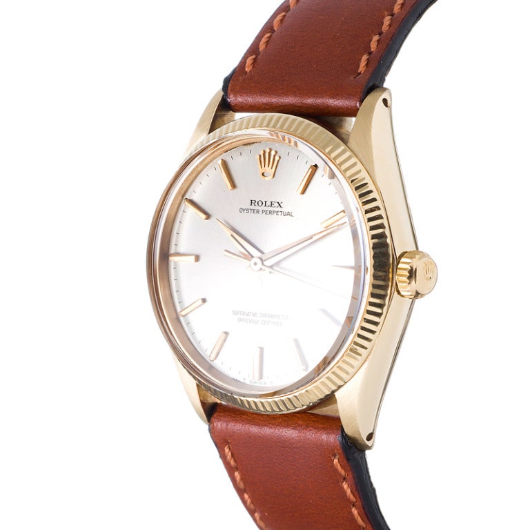 14k yellow gold Rolex Oyster Perpetual wristwatch, a classic standard for the Rolex enthusiast, with a look that is truly timeless, yet the distinctive aesthetic of original stylized vintage hands. Suitable for either a lady or a gentleman with a