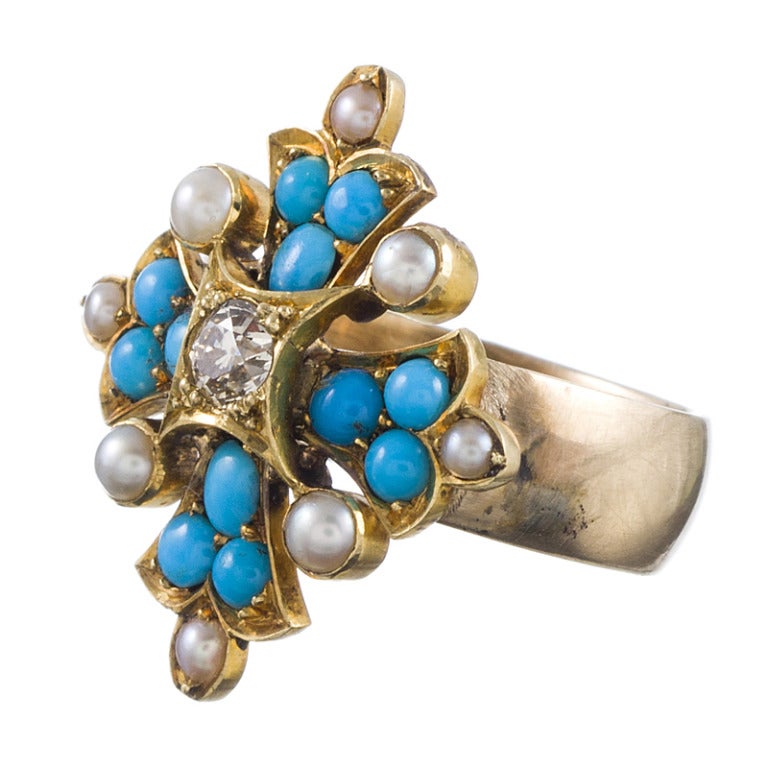 Forming a shape which resembles a Maltese cross, this is a charming antique motif placed on a gold band ring with a subtle edginess. Natural pearls and turquoise cabochons create the body and the center is anchored by an old European cut diamond.