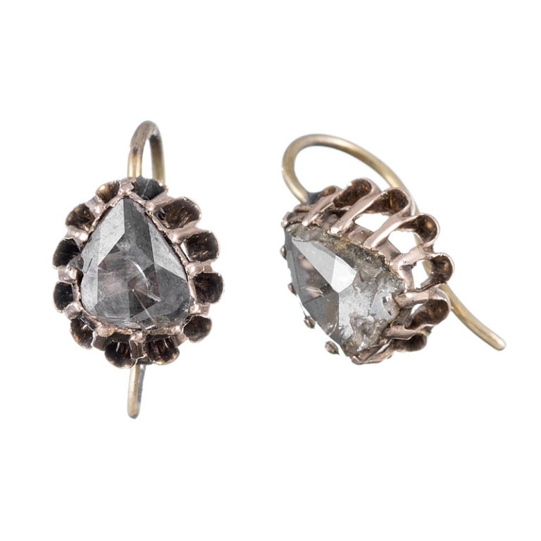 Created one hundred years before the mid-Victorian Era, these incredible earrings are set in 18k rose gold and each contain a foiled rose cut diamond. The earrings are quite substantial and have been well preserved. They drop just a hair over a half